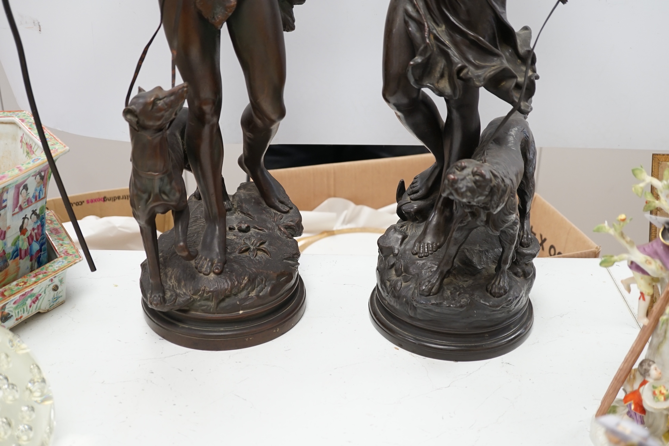 A pair of late 19th century French patinated electrotype figures of a huntsman and Diana, 72cm. Condition - poor to fair